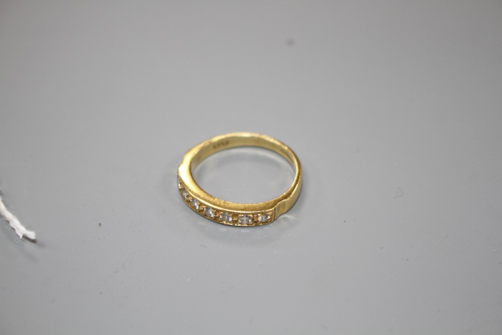 A modern 18ct gold and seven stone diamond set half eternity ring, size R, gross weight 4.9 grams.